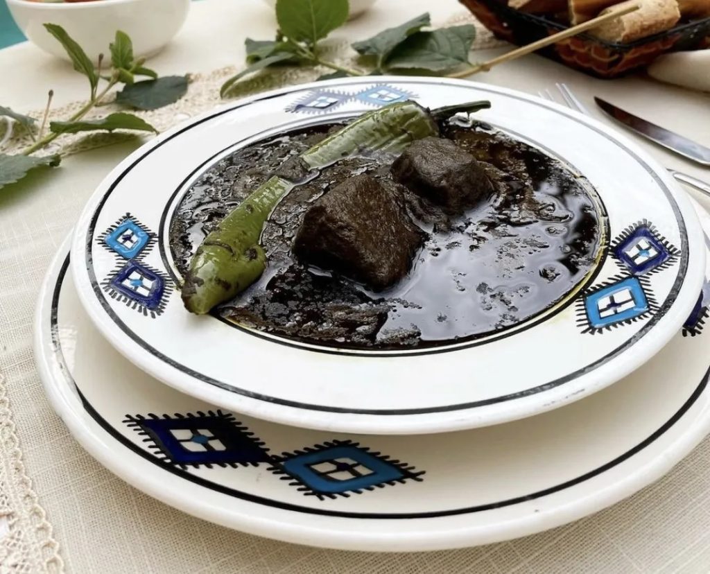 Tunisian mloukhia is a slow-cooked stew made from powdered jute leaves, olive oil, and tender meat. With its bold flavor and deep heritage