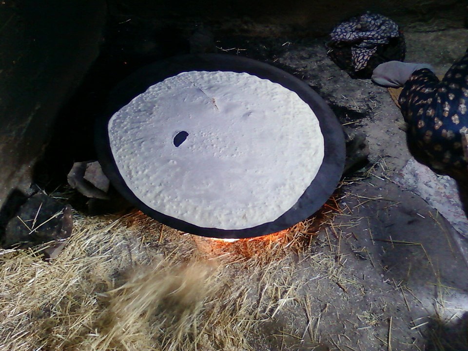 The saj is a large, round metal griddle used over an open flame to bake thin flatbreads, such as markook, shrāk, or khubz saj. 