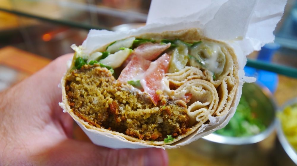 Shawarma (شاورما) – Marinated meat stacked on a vertical spit, shaved to order into wraps with toum (garlic whip), pickles, and fries. A Levantine street icon and one of Lebanon’s most recognized exports.