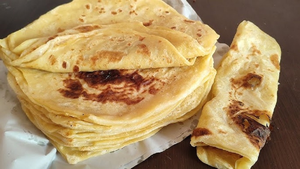 Tunisian Mlaoui bread, a traditional layered flatbread with a flaky texture, rich cultural history, and modern culinary appeal.