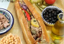 Tunisian kaskrout lablabi, a popular street food sandwich made with chickpeas, harissa, olive oil, tuna, and egg. A true taste of Tunisia’s culinary heritage.