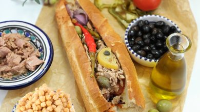 Tunisian kaskrout lablabi, a popular street food sandwich made with chickpeas, harissa, olive oil, tuna, and egg. A true taste of Tunisia’s culinary heritage.