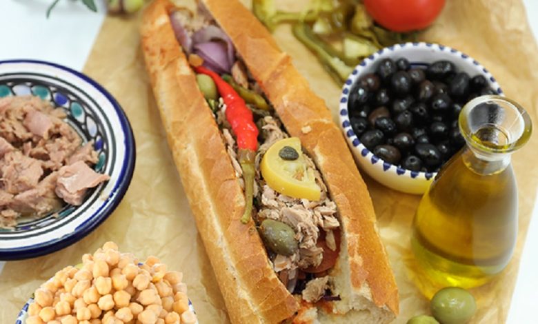 Tunisian kaskrout lablabi, a popular street food sandwich made with chickpeas, harissa, olive oil, tuna, and egg. A true taste of Tunisia’s culinary heritage.