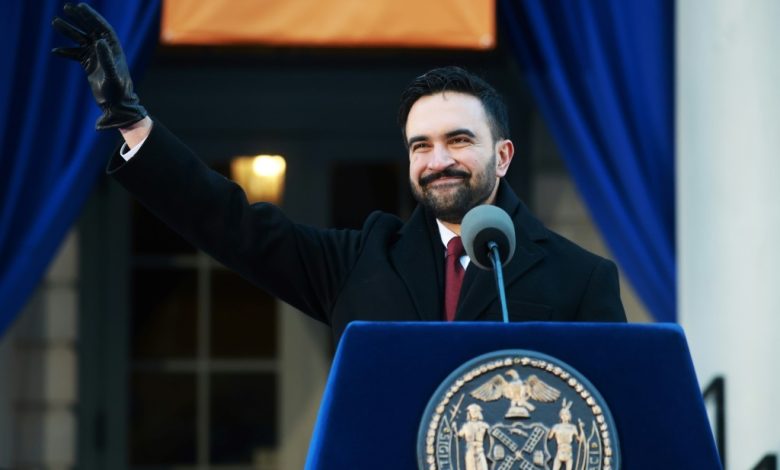 Dressed in heavy clothing to withstand the bitter cold and visibly battling a cold, Mamdani was accompanied by a camera crew. He repeatedly stopped to greet neighbors who wished him well. Aboard the Manhattan-bound train, under limited security, the new mayor agreed to take selfies with surprised commuters before settling into a corner seat to review briefing materials for his first day. When two French tourists doubted his identity, Mamdani introduced himself as “the new mayor of New York City” and showed them a copy of the New York Daily News featuring his photo on the front page. While riding the subway is not unprecedented for New York City mayors—Eric Adams, Bill de Blasio, and Michael Bloomberg all did so—images of Mamdani spread rapidly on social media. Supporters viewed them as a visual fulfillment of his inaugural pledge that his administration would “look like and live like the people it represents.”